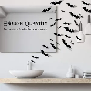Pack of 3D black bat wall decals applied to a bathroom mirror for Halloween scene