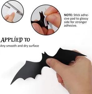 Instructional view of applying adhesive pads to a 3D Halloween bat wall sticker