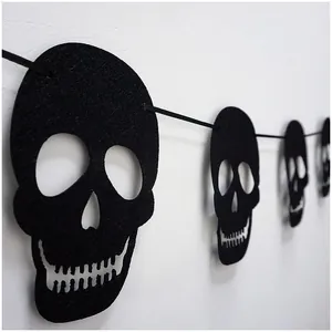 Close-up detail of black felt skull banner garland for Halloween party room decor
