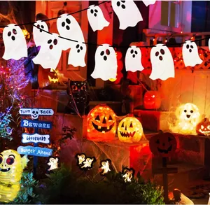 Scene showing white ghost felt garland hanging on a porch for Halloween decoration.