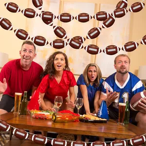 Detailed view of American football party banners hung in a lively home party setting.