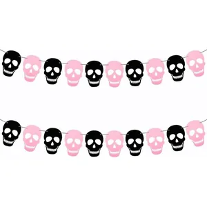 Close-up of alternating pink and black felt skull garland for Halloween party decoration
