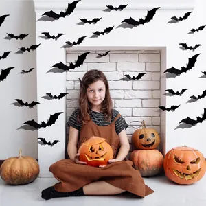 Detailed view of 3D Halloween bat wall stickers in a cozy festive fireplace setting