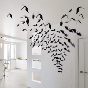 Realistic 3D black bat wall decals applied to a white interior wall for Halloween.