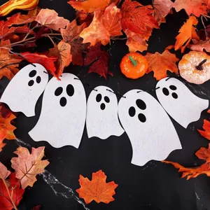 Cute white felt ghost Halloween garland hanging banner with autumn leaves and pumpkins.