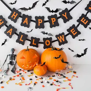 Close-up of Happy Halloween banner and black bat wall stickers for festive party decor