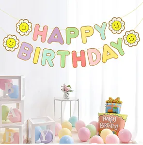 Sunflower happy birthday banner with pastel macaron balloons in a festive party setting