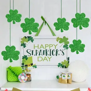 Festive green glitter shamrock hanging decorations for St. Patrick's Day party setting