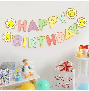 Detail of pastel macaron color Happy Birthday banner with smiling sunflowers decoration
