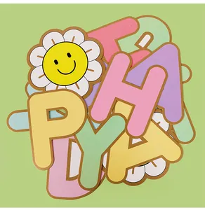 Close-up of macaroon colored alphabet birthday banner with smiling sunflower detail