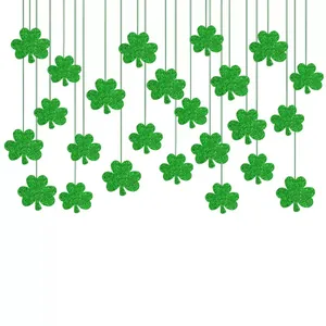 Detail view of green glitter shamrock hanging decorations for St. Patrick's Day party.
