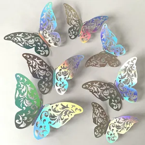 Detail of iridescent laser-cut butterfly wall stickers with intricate hollow patterns.