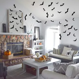 Living room decorated with various sizes of 3D black bat wall stickers for Halloween