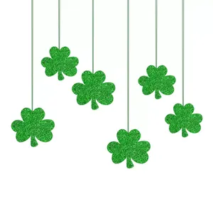 Close-up detail of green glitter shamrocks hanging for St. Patrick's Day party decor