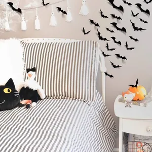 Detail of 3D black bat wall stickers applied to a bedroom wall for Halloween decor