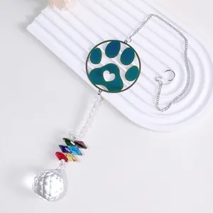 Close-up of paw print suncatcher with colorful crystals and a large faceted glass ball