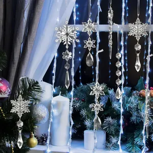Detailed view of clear acrylic snowflake and icicle ornaments hanging in a window
