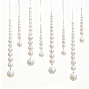 Detailed view of elegant white pearl beaded Christmas ornaments with graduated sizes