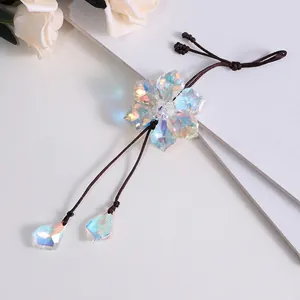 Detailed macro shot of an iridescent crystal flower car rearview mirror hanging ornament.