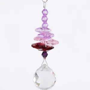Detailed view of a crystal suncatcher with purple octagonal beads and a clear faceted ball.