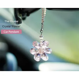 Detailed macro shot of a multi-faceted crystal flower suncatcher pendant for car decoration