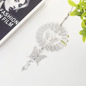 Detailed view of a 3D metal butterfly wind spinner with a crystal teardrop pendant.