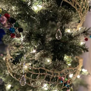 Close-up detail of faceted acrylic teardrop crystals hanging on a decorated Christmas tree