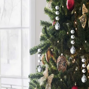 Macro detail of clear acrylic crystal teardrop ornaments on a decorated Christmas tree