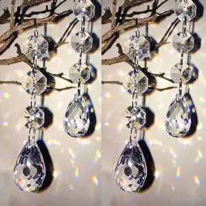 Close-up of faceted acrylic crystal teardrop beads reflecting rainbow light prisms