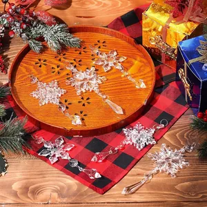 Elegant clear acrylic snowflake ornaments for Christmas tree decor in festive lifestyle setting.