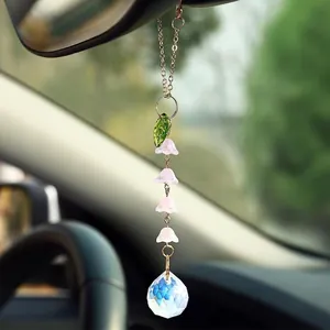 Detail of lily of the valley suncatcher with pink flowers and crystal ball for car