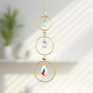 Close-up of golden suncatcher with iridescent teardrop crystals for window decor