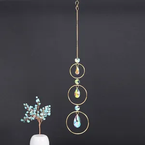 Detail of golden suncatcher with iridescent teardrop crystals for windows
