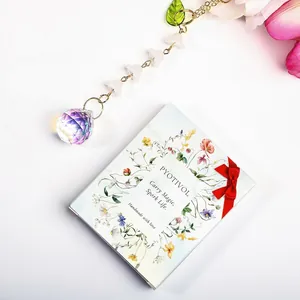 Detail view of crystal suncatcher with lily of the valley beads and elegant floral card.