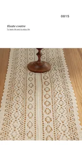 Detailed macro view of vintage hollow crochet lace table runner with cotton texture