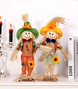 Close-up detail of two decorative Halloween scarecrow dolls for autumn harvest display