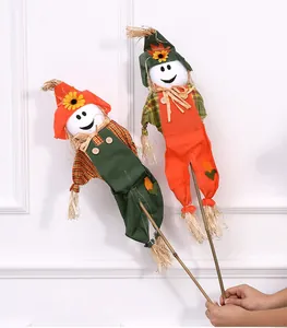 Detail of two smiling Halloween scarecrows on sticks for festive shop window decor