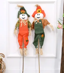 Detail of two colorful Halloween scarecrow decorations with friendly smiley faces