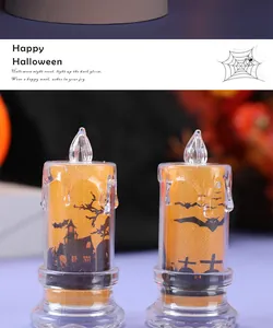 Close-up of decorative Halloween LED candle lights with haunted house and bat prints