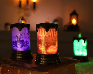 Atmospheric Halloween LED candle lights with pumpkin and witch motifs on a vintage book