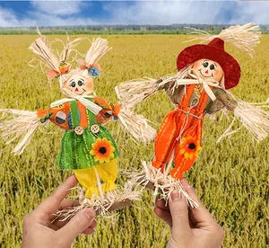Details of two standing scarecrow dolls for Halloween harvest theme garden decoration