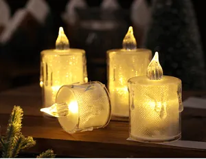 Close-up of glowing crystal LED candles on a wooden table with festive decor.