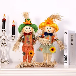 Set of two cute Halloween scarecrow dolls standing for harvest festival home table decor.