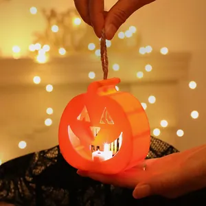 Handheld mini Halloween LED pumpkin lantern with warm glowing lights for party decoration