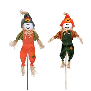 Set of two decorative Halloween scarecrows with smiley faces on wooden sticks for decor