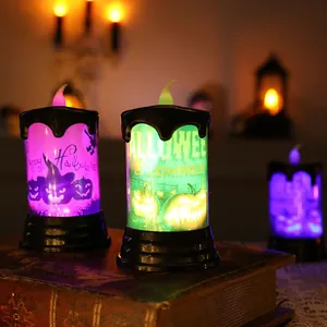 Decorative Halloween LED pumpkin candles on a vintage book with atmospheric spooky lighting