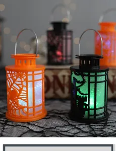 Close-up view of decorative Halloween lanterns with spider web and castle cut-outs