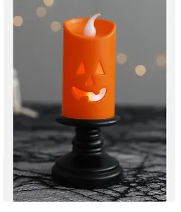 Close-up view of Halloween jack-o-lantern LED candle lamp with black pedestal base