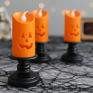 Halloween LED pumpkin candle lights with black holders for spooky festive table decor