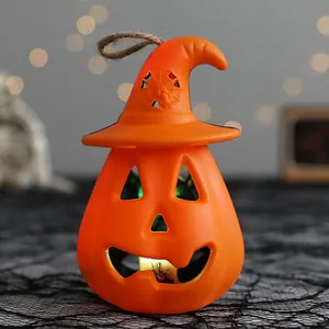 Halloween light-up pumpkin lantern with witch hat and hollowed spider web pattern